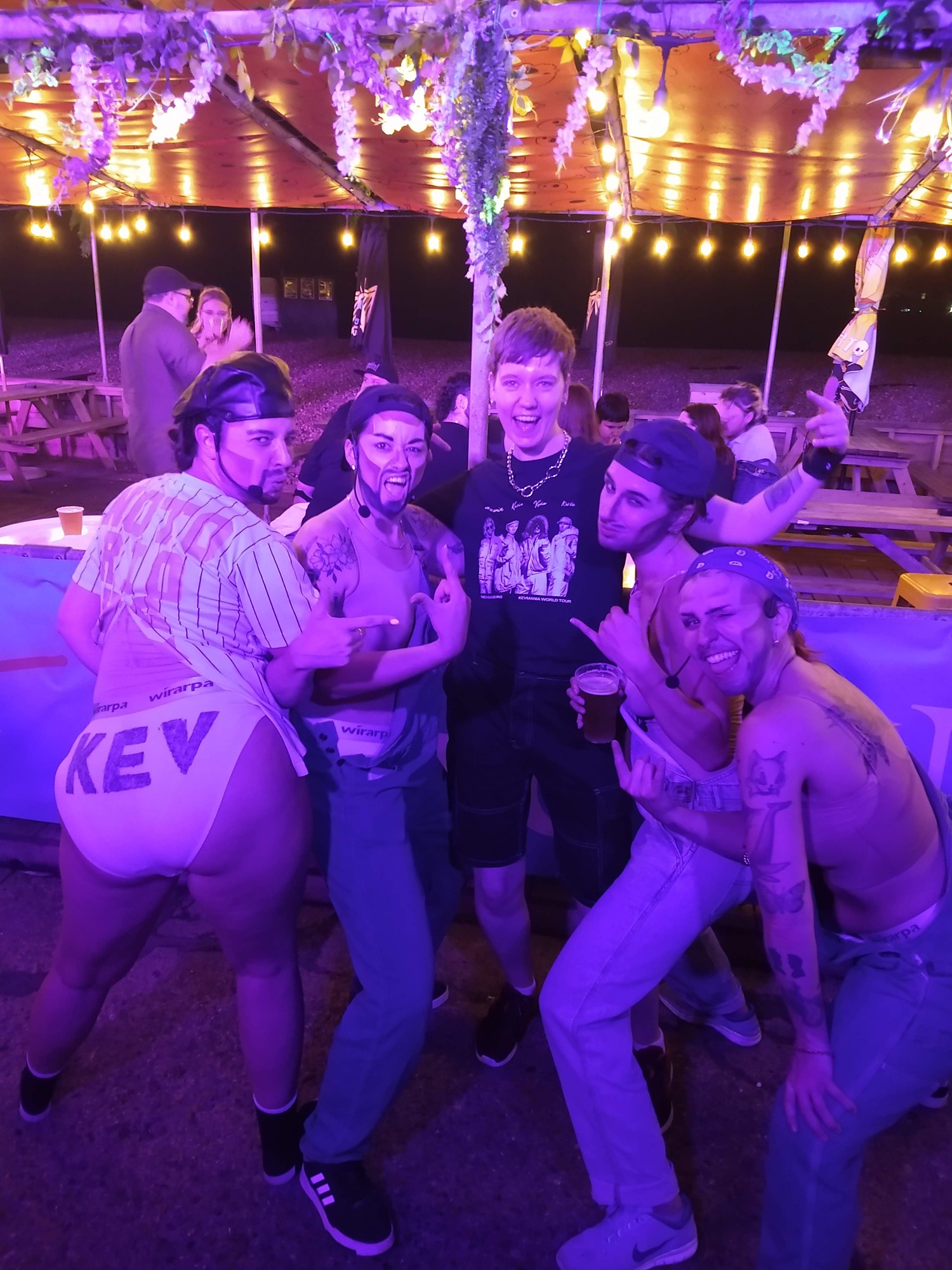 Roxy is surrounded by the four drag performers that make up the S Club Kevins