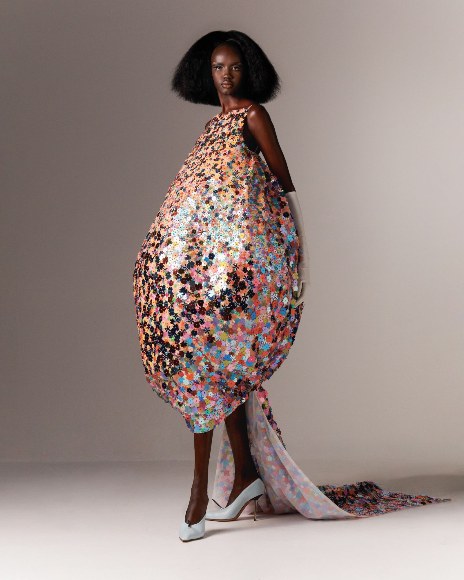 Model wearing a bubble shaped dress covered in bespoke cut flower sequins
