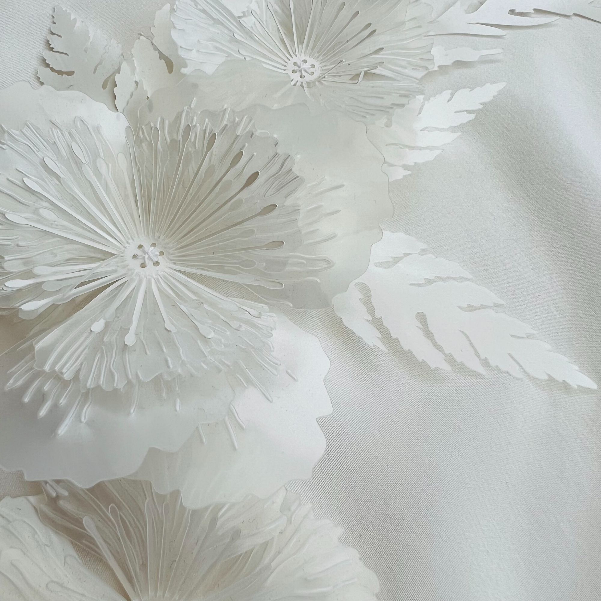 Delicate white flower sequins made from biobased, biodegradable polymer plastic