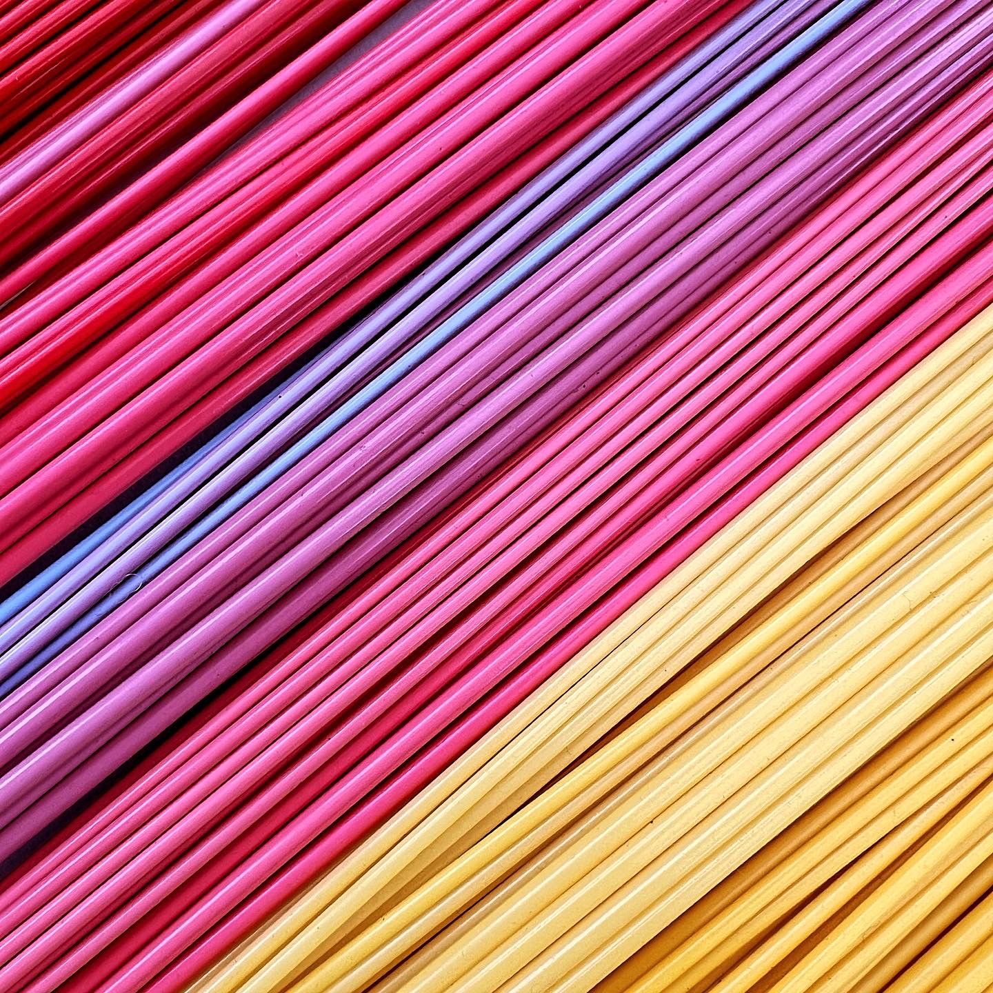 Pile of brightly coloured thin bioplastic tubes fro bead making