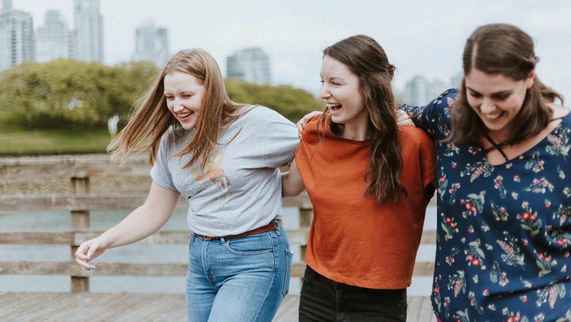 3 women in colourful clothes walking outside