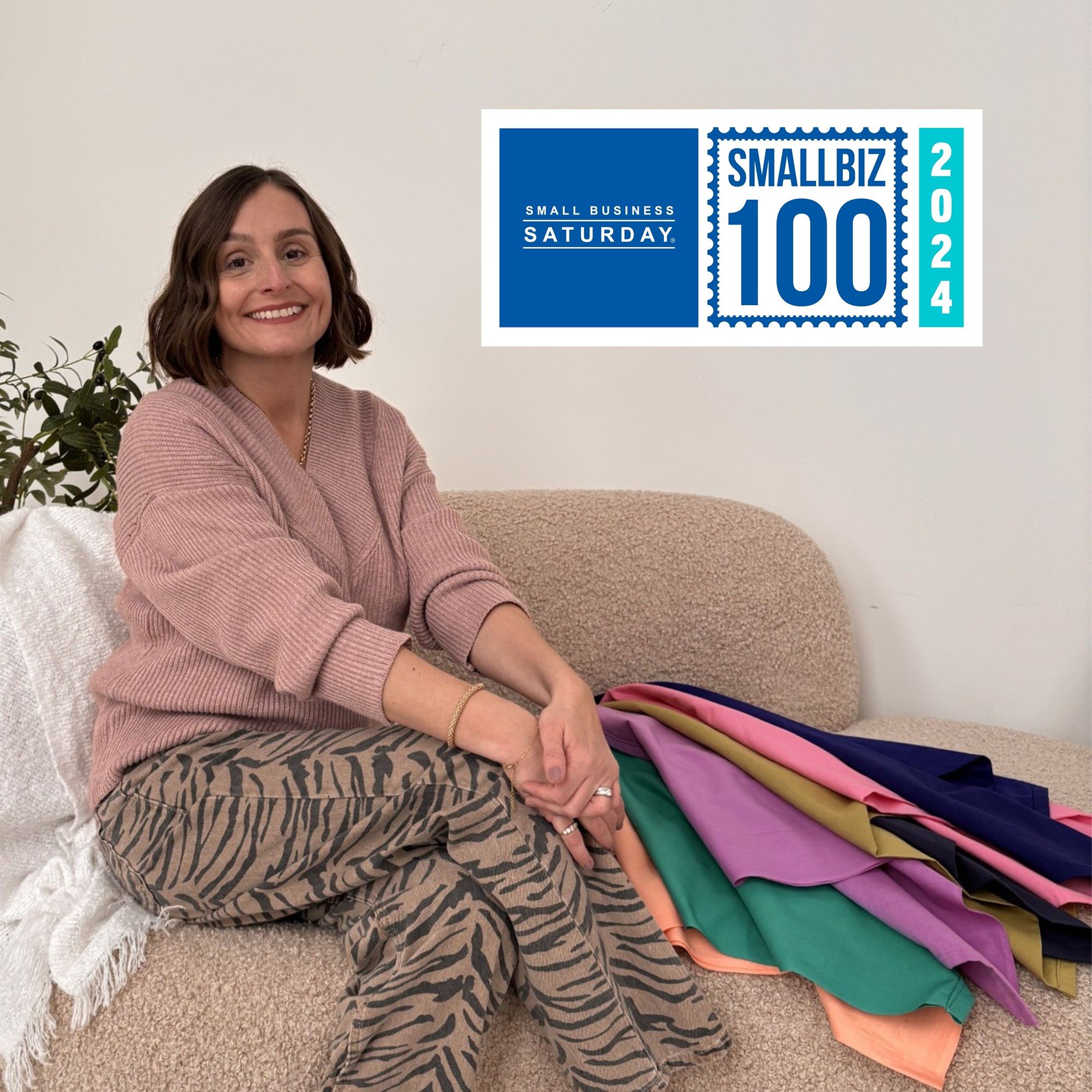 Surrey fashion stylist Ali Lees sitting on sofa with colour analysis drapes, wearing a pink jumper and zebra print jeans