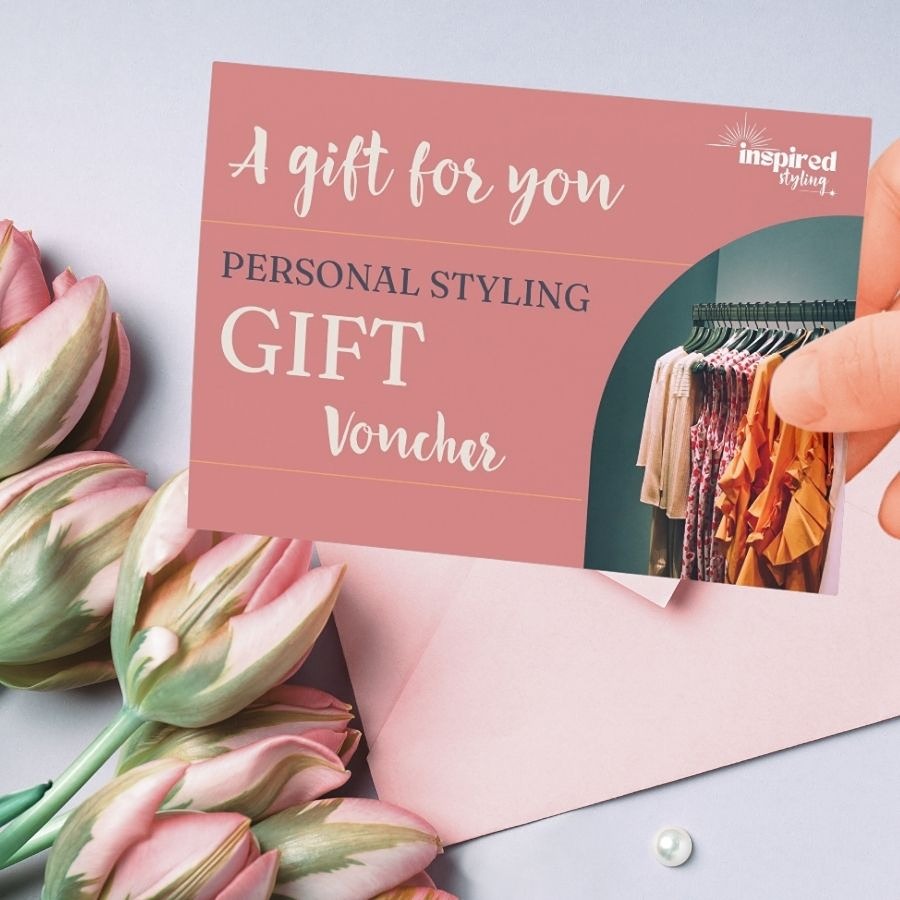 Pink personal stylist gift voucher valid on personal colour analysis and other styling services, next to a pink gift envelope and pink tulips