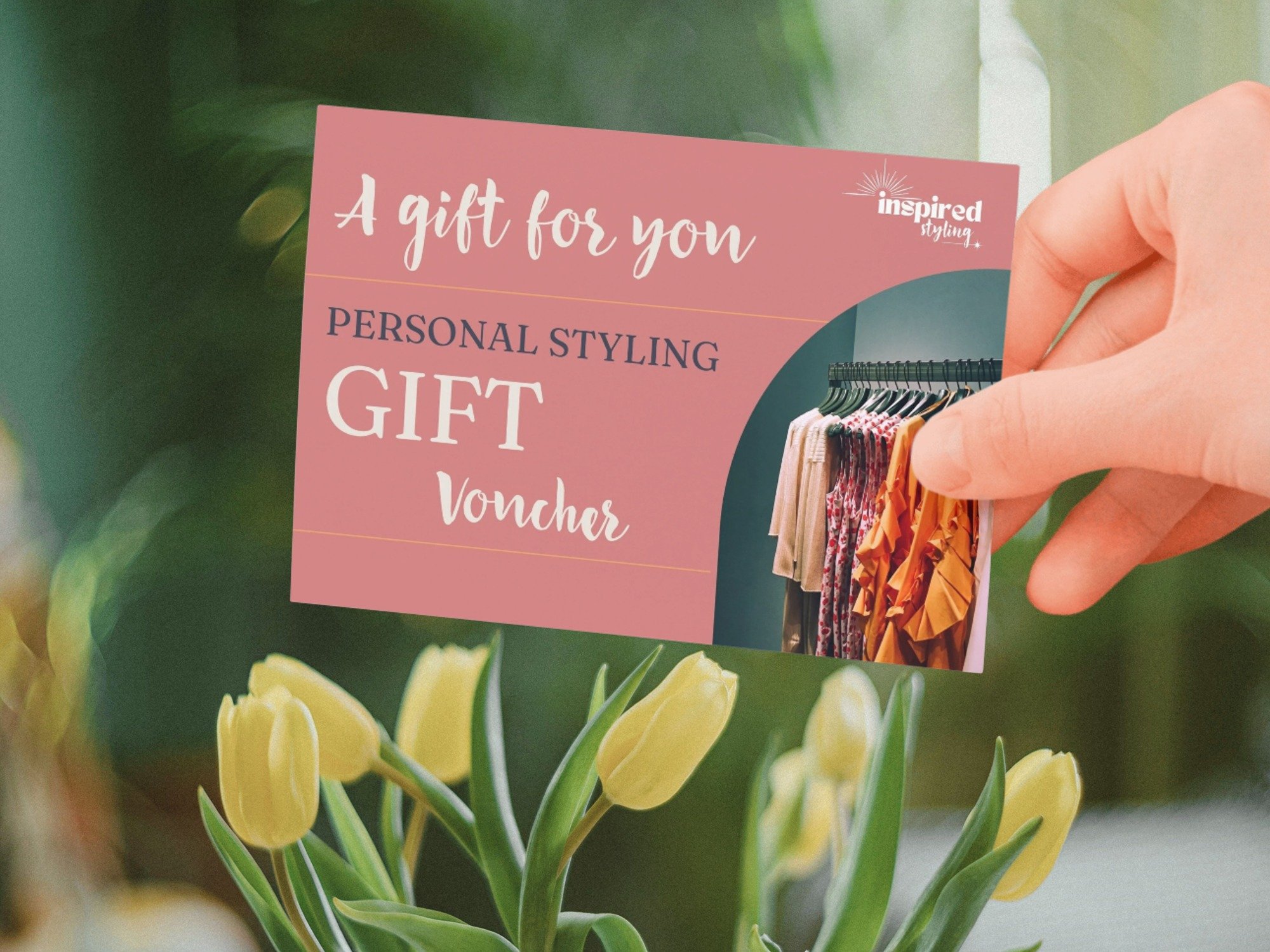 Gift wrapped parcel tied with golden ribbon with dried flowers attached