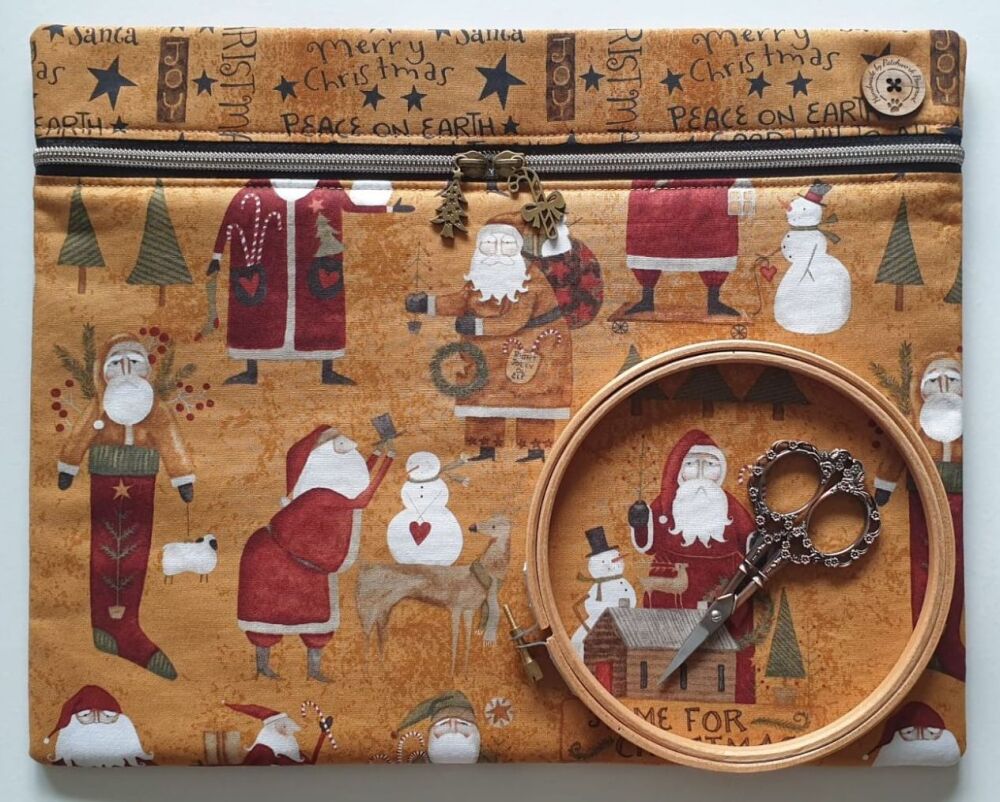 Kringle Santa Claus project bag , gold, 14" x 11" with 2-way zip and brass Christmas zip-pulls. Teresa Kogut.