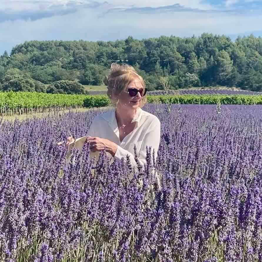 Lucy in a calming lavender field, capturing her connection to nature and relaxed facial treatments in Somerset.