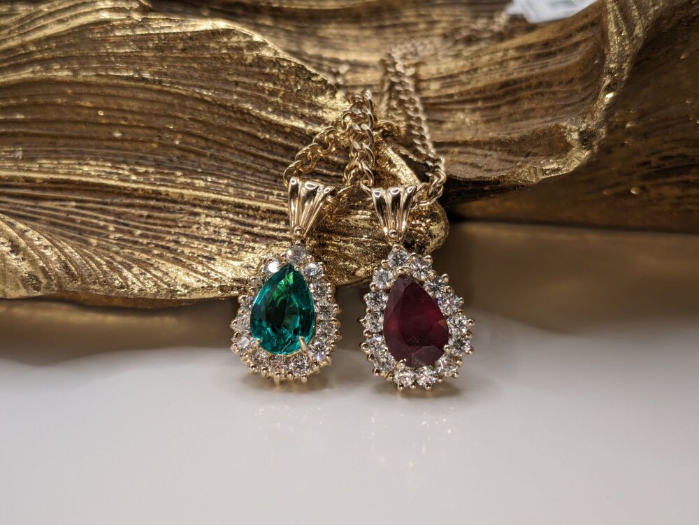 Pear cut Ruby with Diamond halo on 18K Yellow Gold