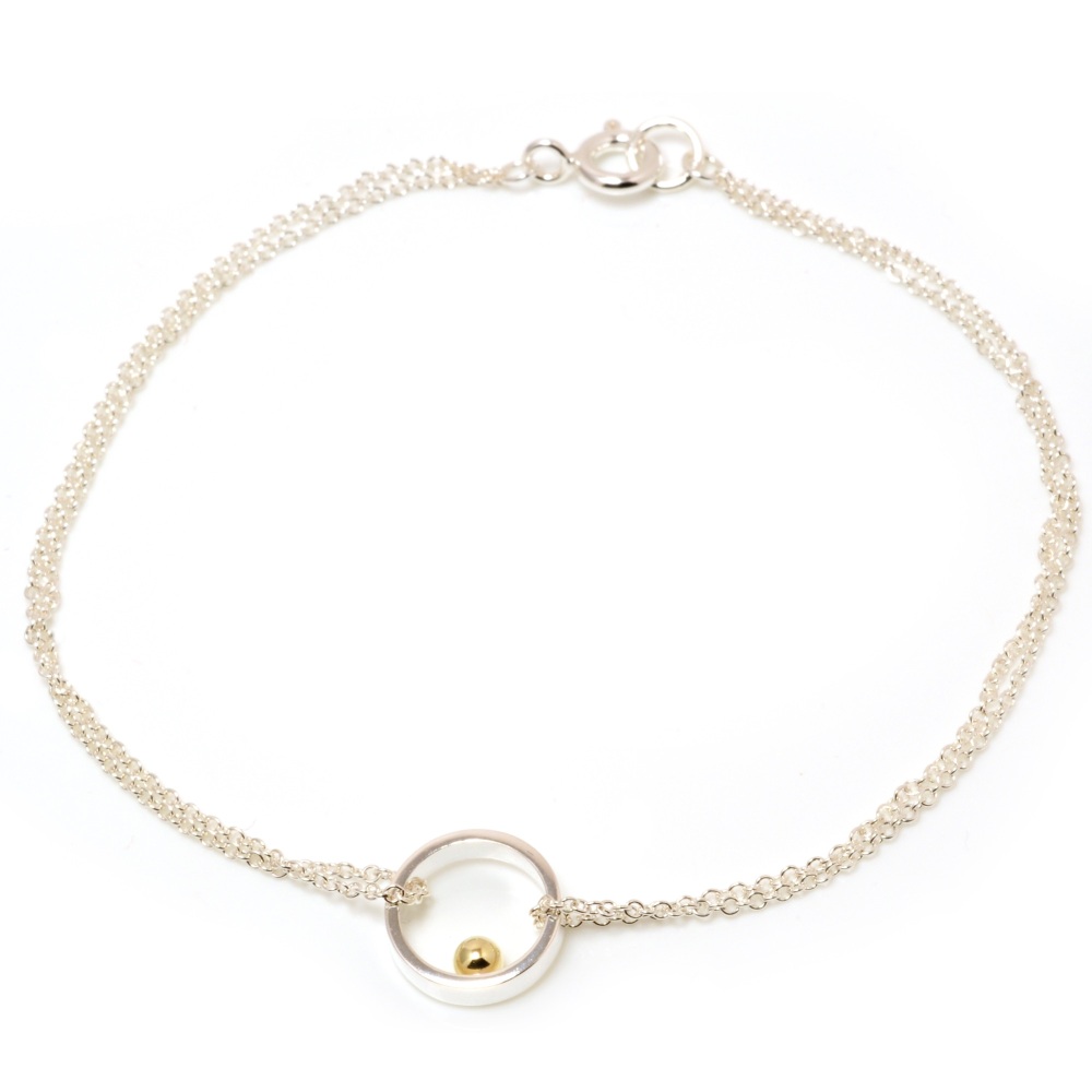 Silver chain bracelet with open circle with gold ball detail
