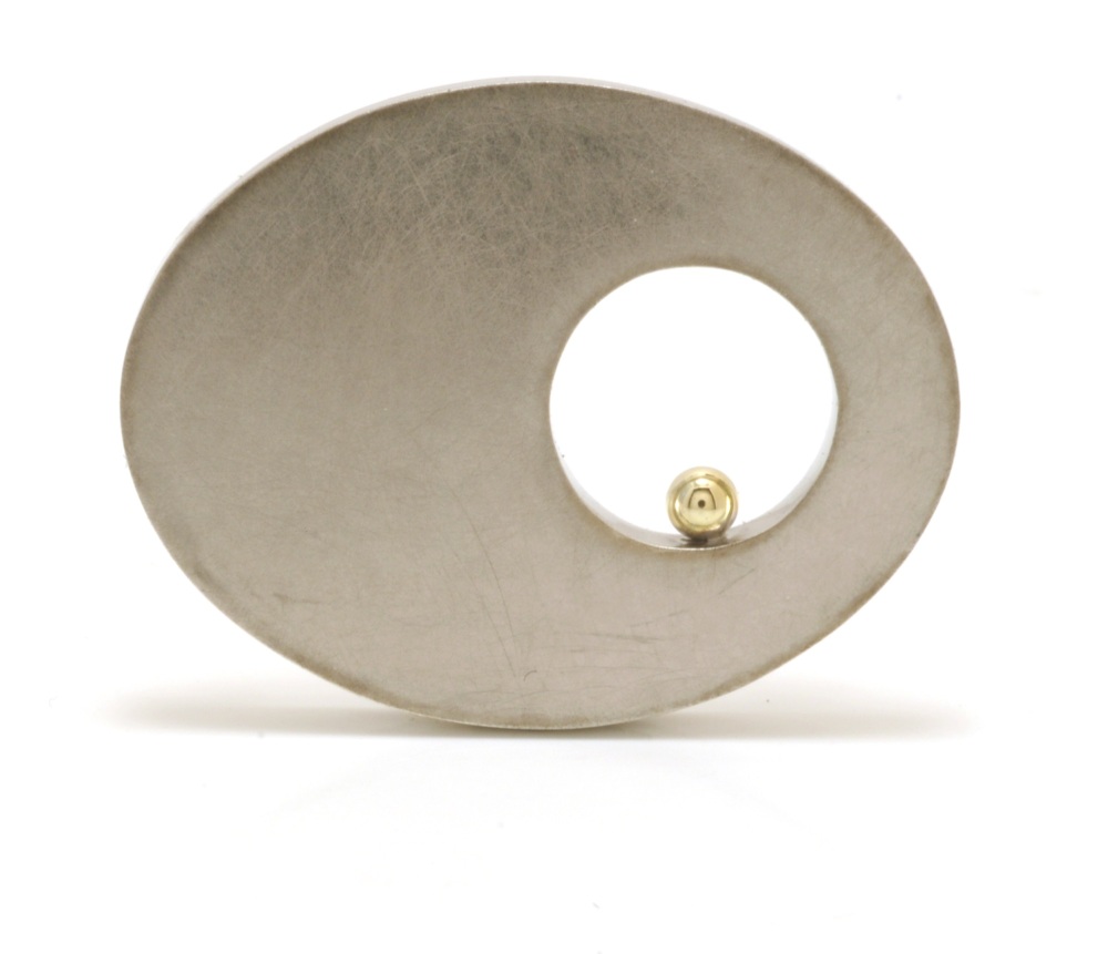 Silver hollow oval brooch with hole and gold ball detail