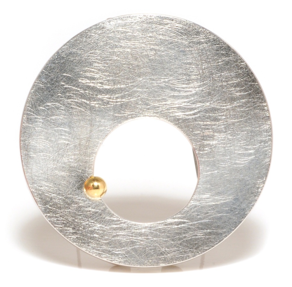 Silver circle brooch with hole and gold ball detail
