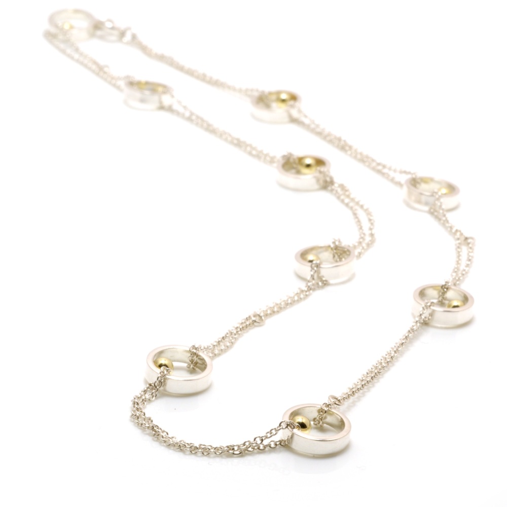 Nine silver open circles with gold ball details looped chain necklace