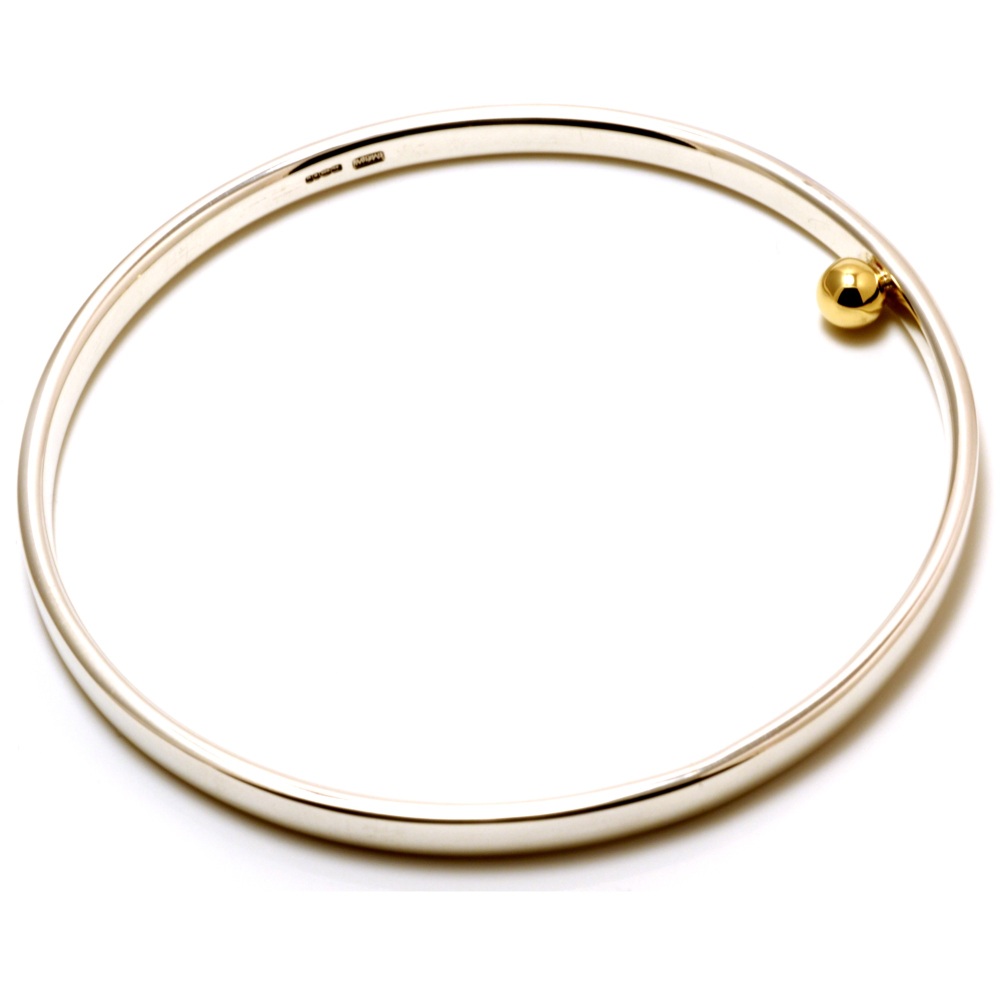 Silver bangle with single solid gold ball