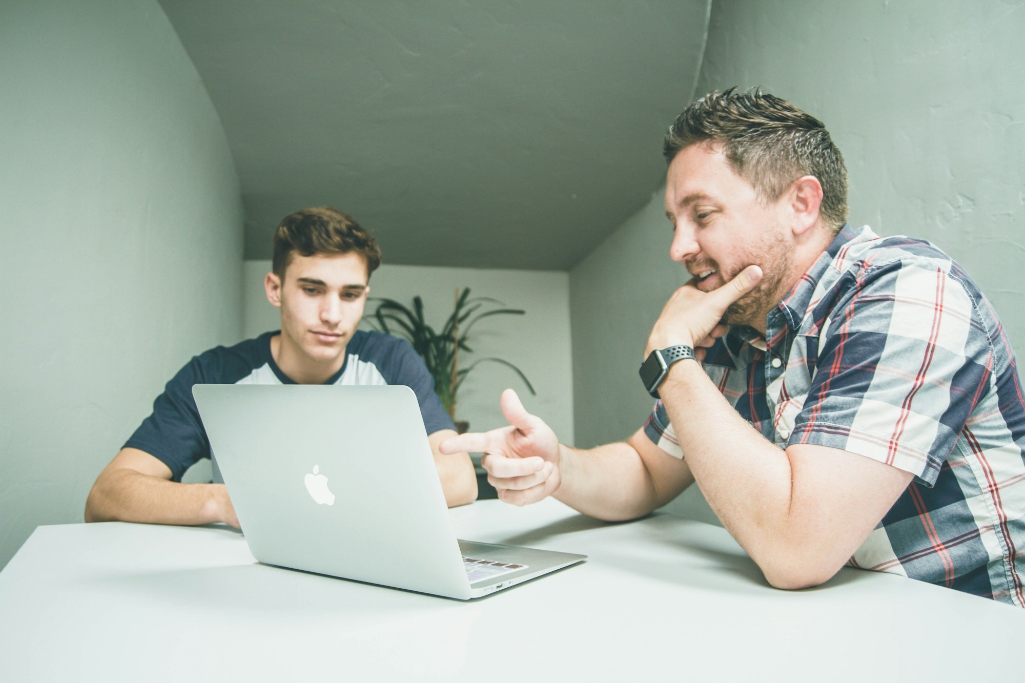 man-wearing-white-and-black-plaid-button-up-sports-shirt-pointing-the-silver-macbook-y_6rqStQBYQ.jpg