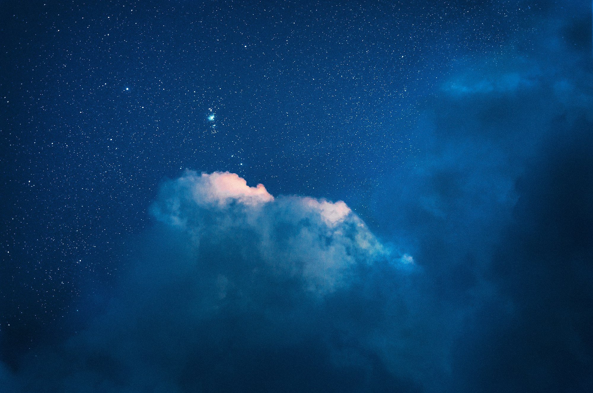 Blue galaxy with stars and a white cloud
