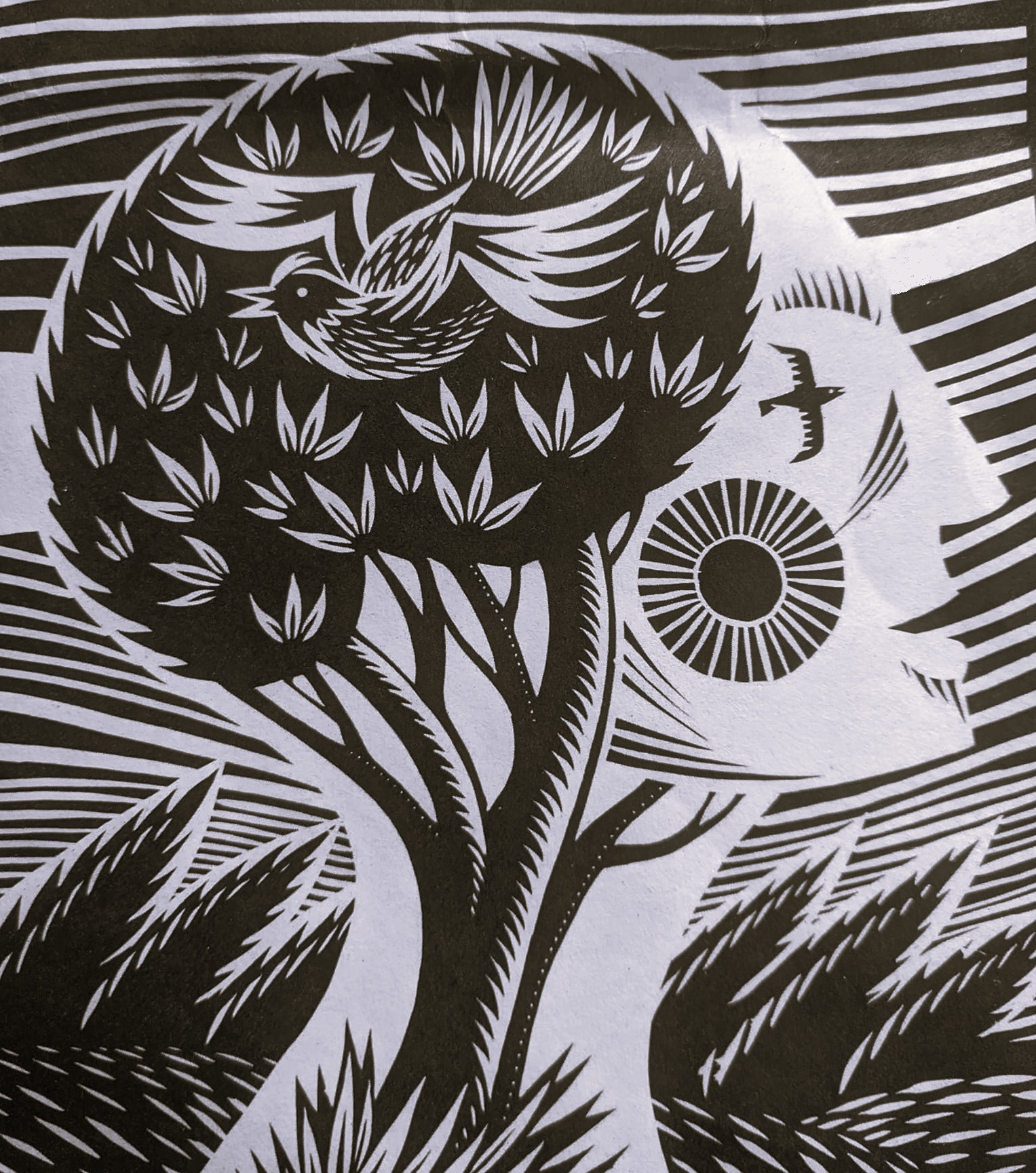 Block print of a head with tree and bird inside it to symbolise emotional growth
