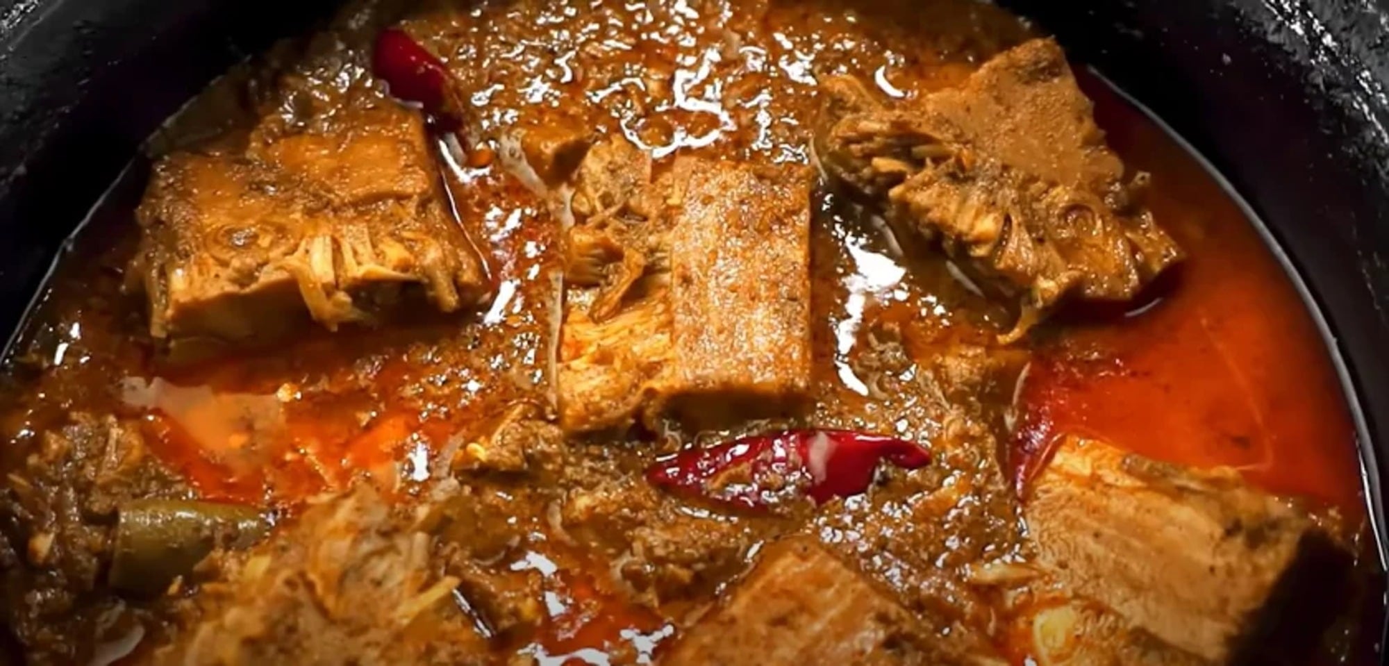 hearty-stew-with-chunks-of-meat-and-red-chili-peppers-a-p0M2ZTlj0