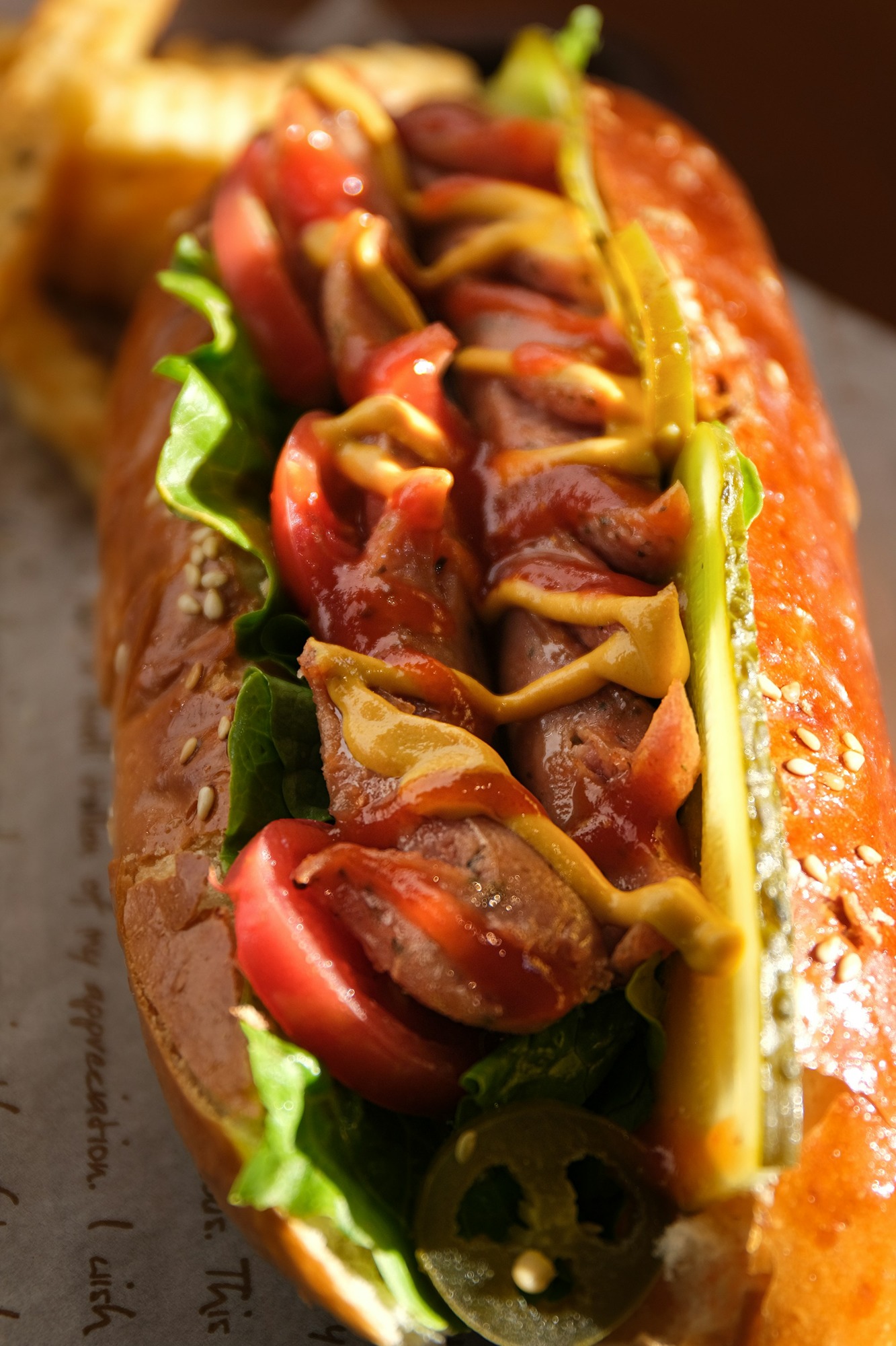 a-hot-dog-with-tomatoes-lettuce-and-mustard-m7w3hVqp0kQ