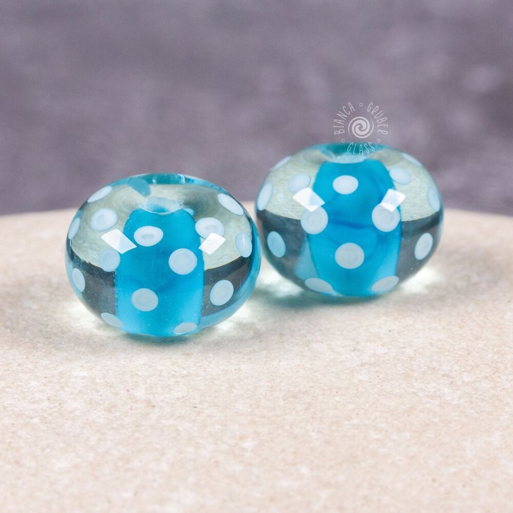Pair of encased small dot beads - blue