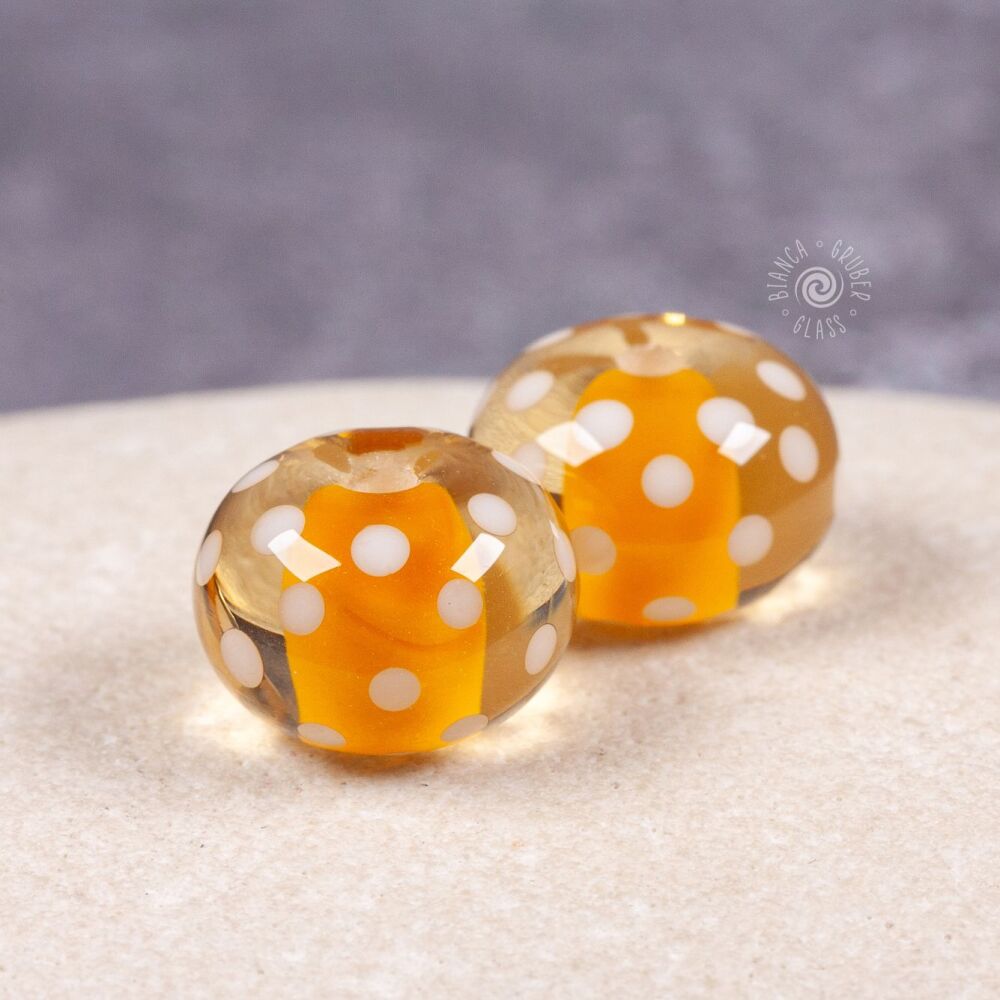 Pair of encased small dot beads - warm yellow