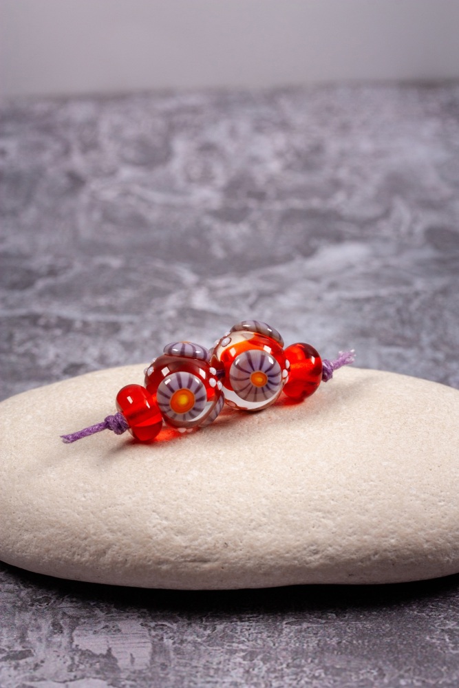 Marmalade orange cored, clear encased beads with purple murrini