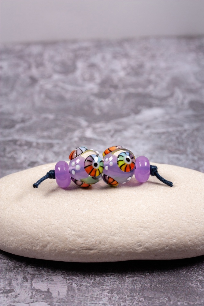 Pinky-purple round beads with rainbow murrini bead pair set
