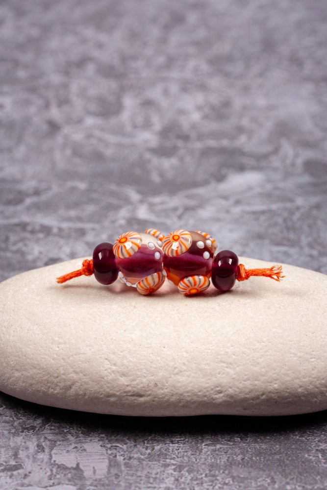 Dark purple round beads with stripy murrini bead pair set