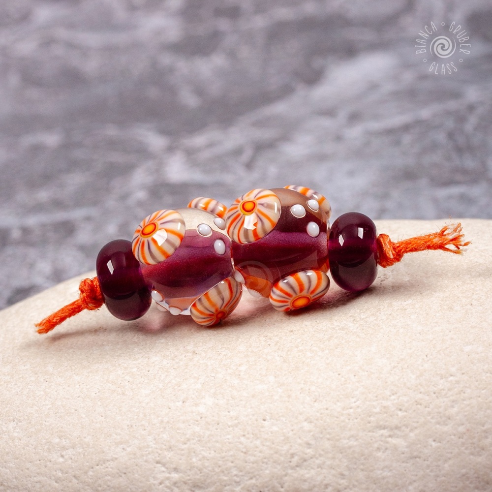 Dark purple round beads with stripy murrini bead pair set