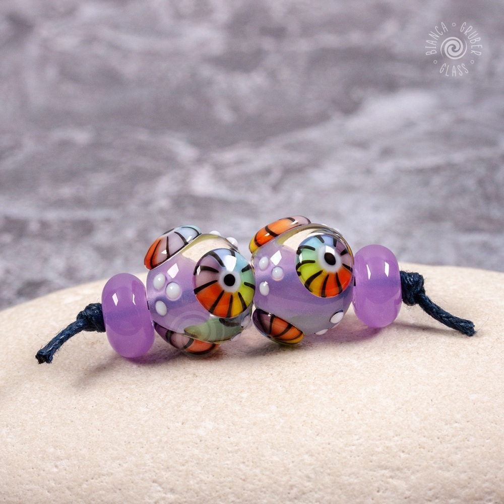 Pinky-purple round beads with rainbow murrini bead pair set