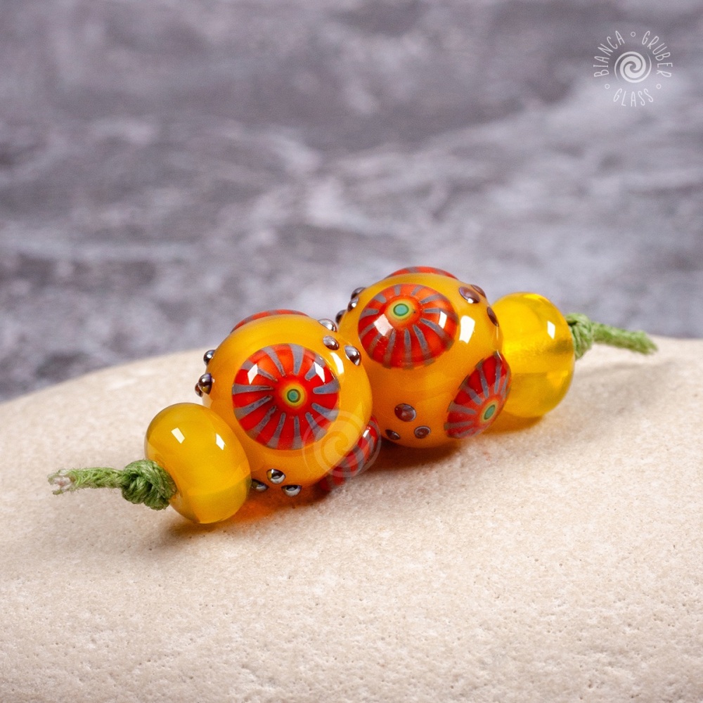 Yellow round beads with orange murrini bead pair set