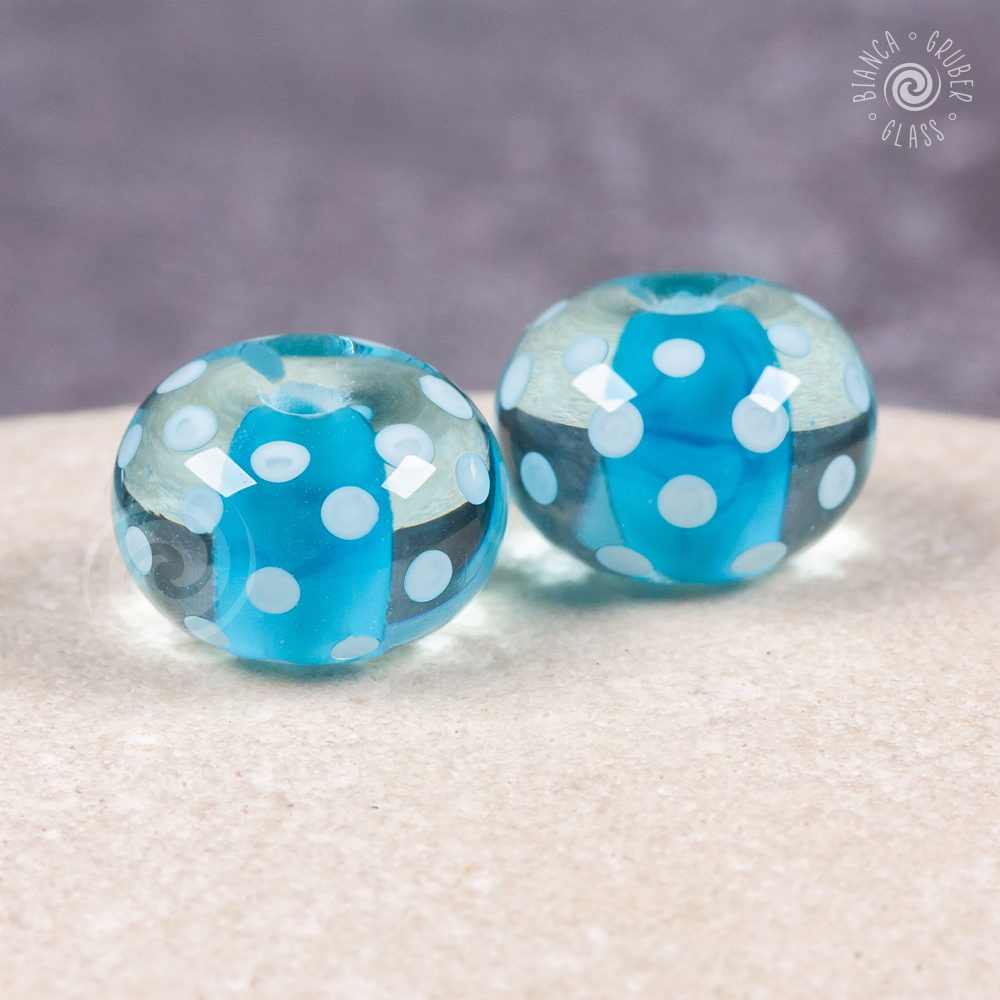 Pair of encased small dot beads - blue