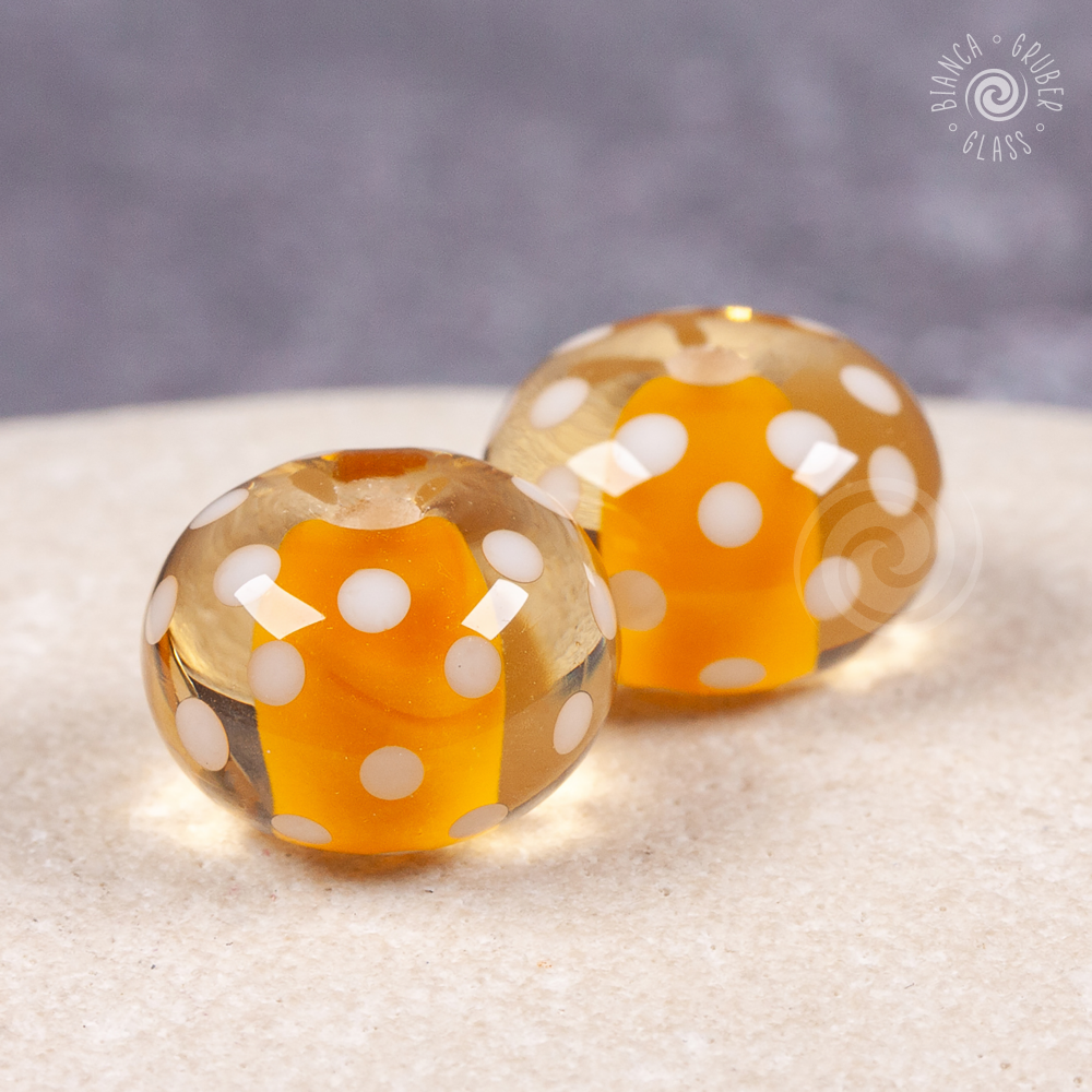 Pair of encased small dot beads - warm yellow
