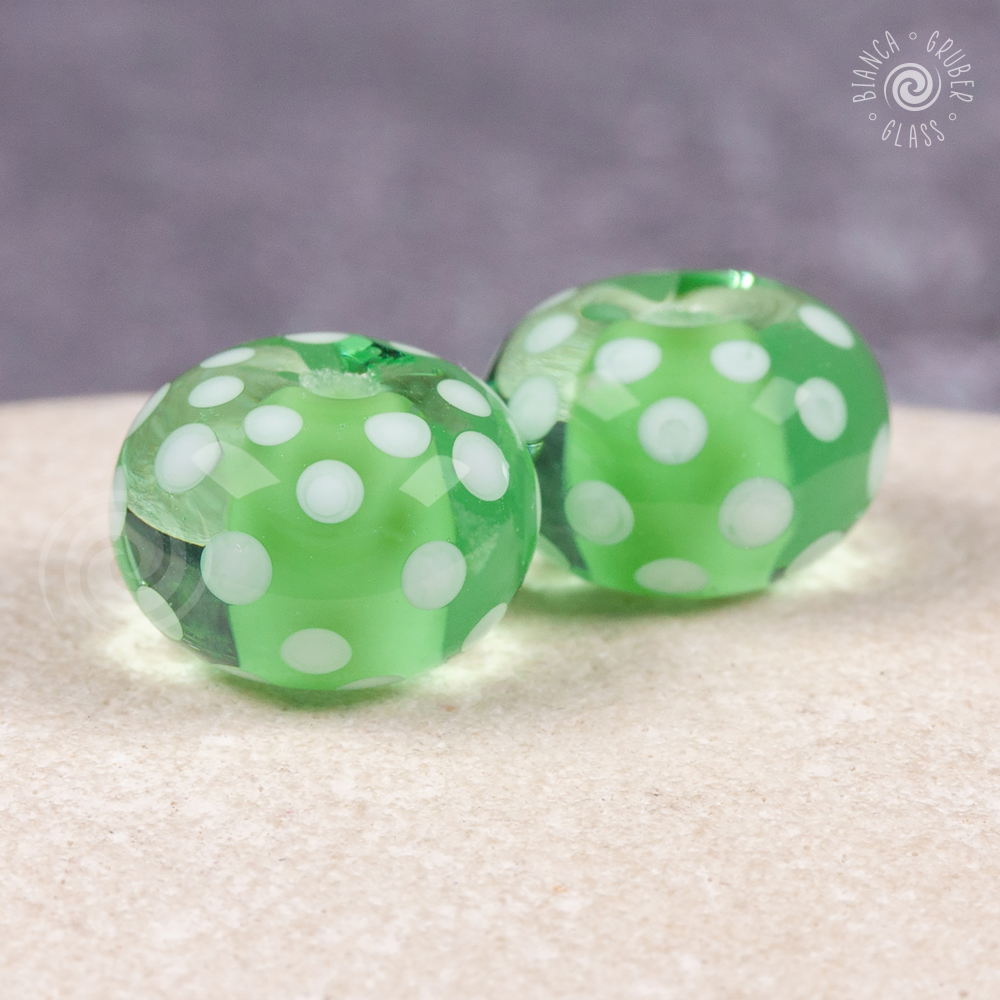 Pair of encased small dot beads - green