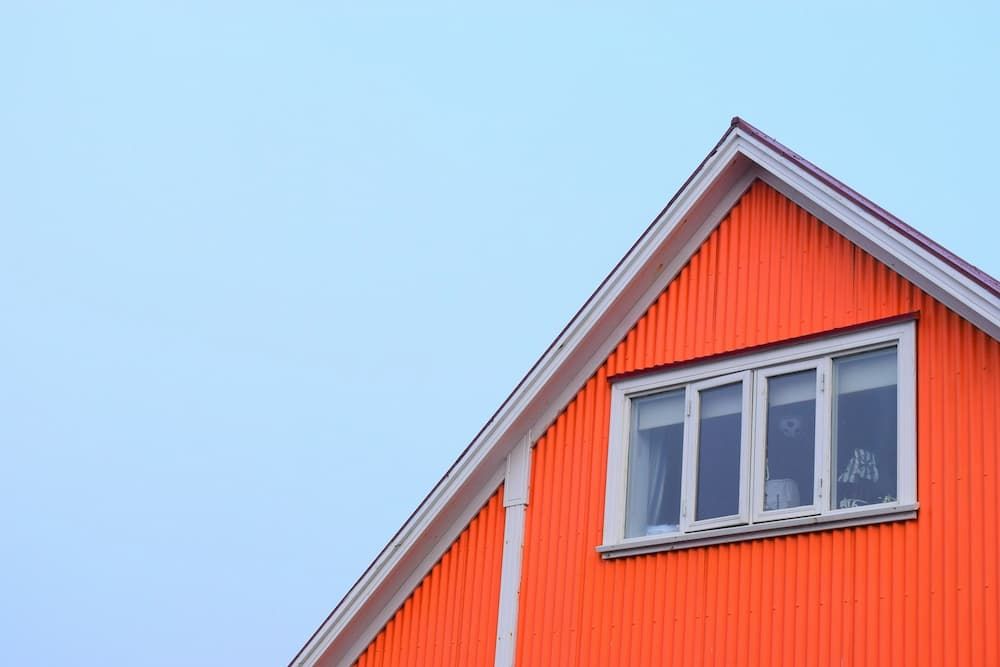 just the top gable end of a nice house with blue cloudless sky backdrop