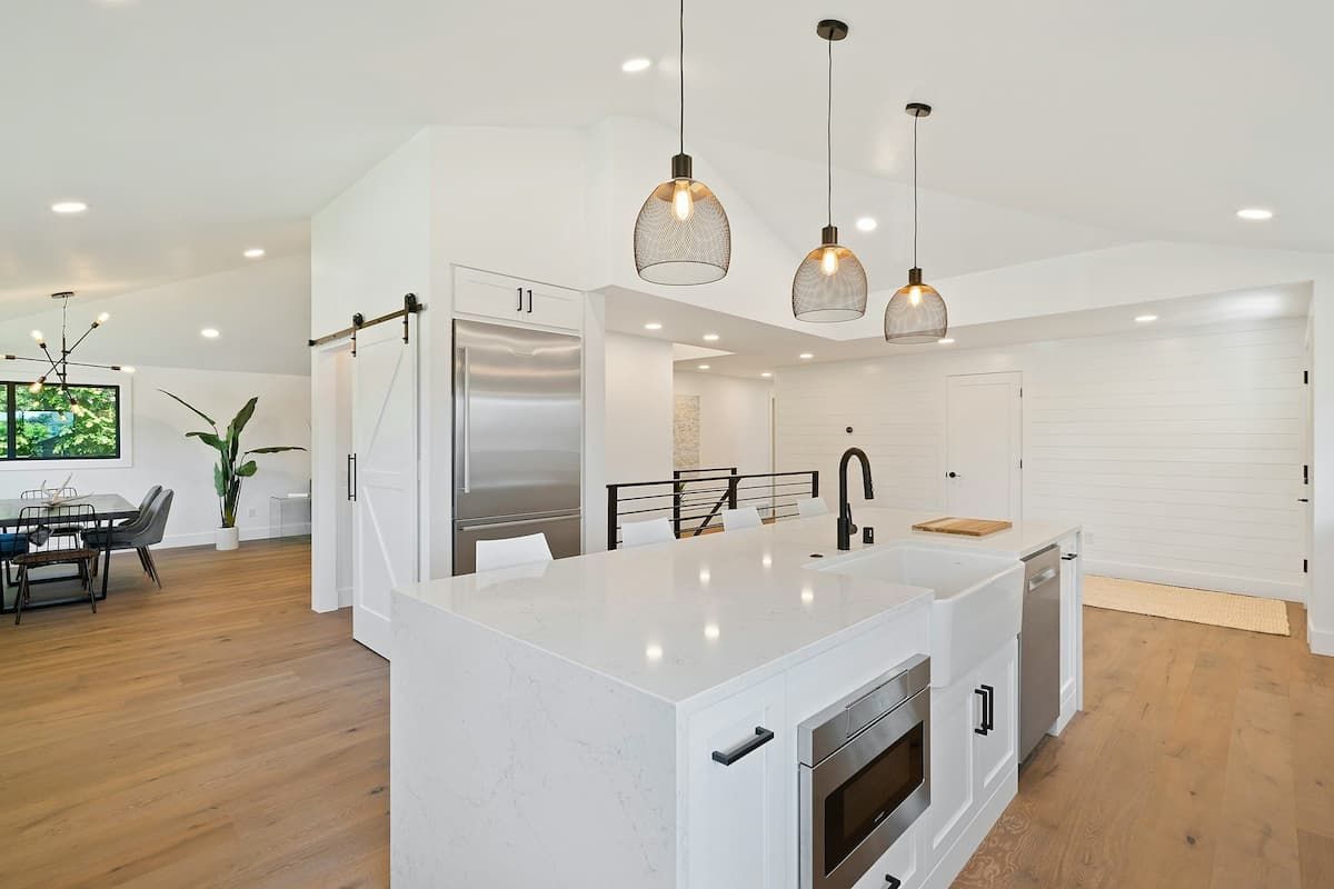 a beautiful high end kitchen in white gloss large open space