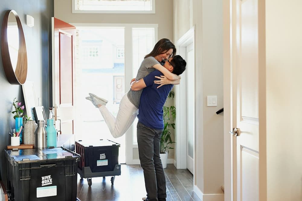 Home Mover Mortgages: happy couple celebrating buying their new house.