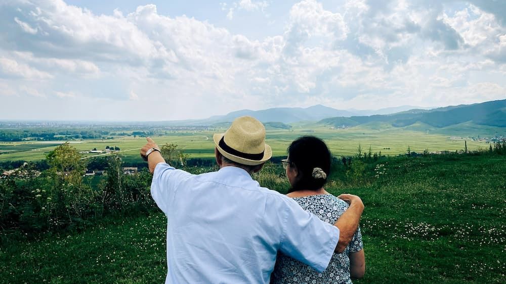 Over 50s guaranteed acceptance: couple looking at countryside view.