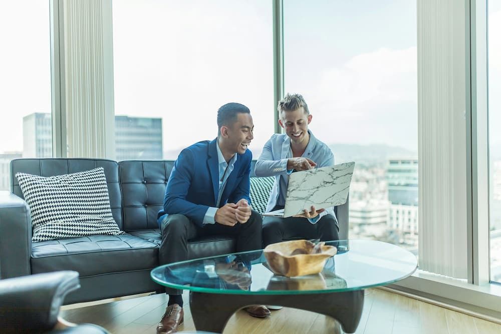 two men working on a laptop