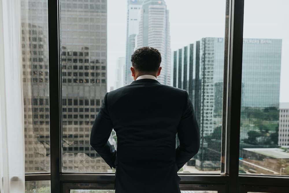 Man standing in fron of glass window