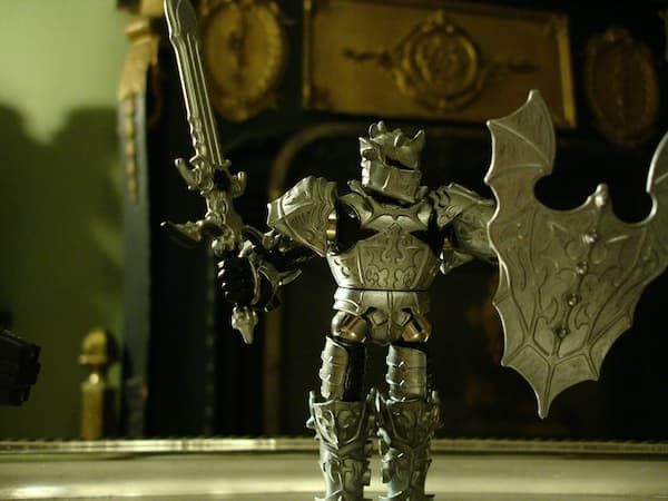 a toy knight holding a sword and shield