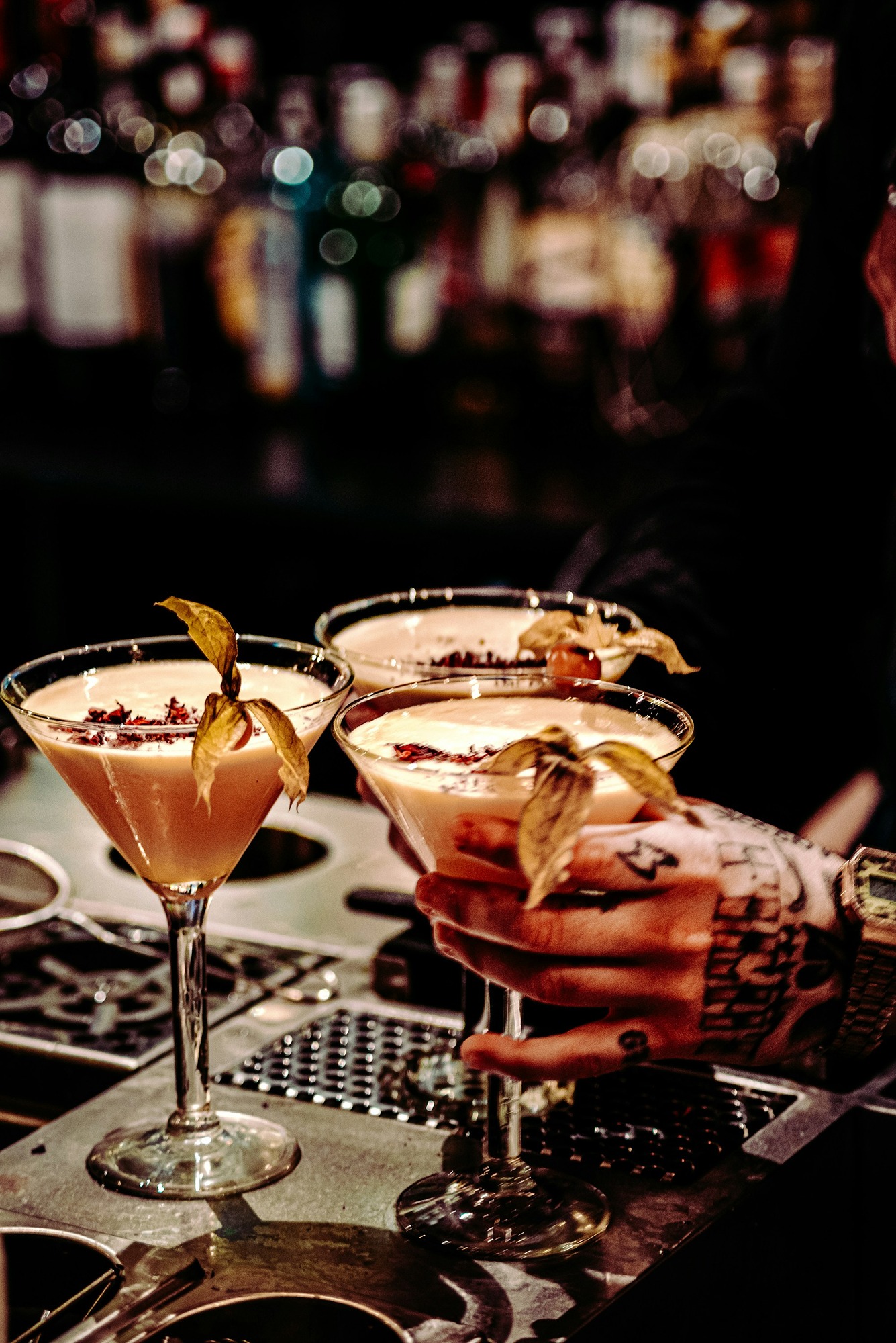 People holding cocktails in cocktail glasses