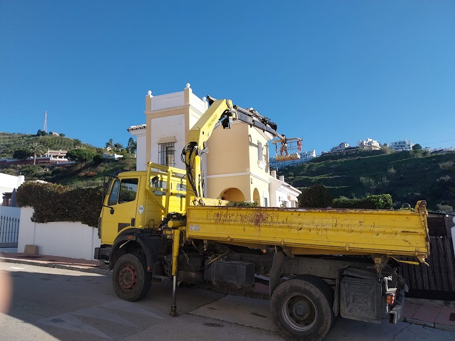 Professional exterior house painting for a villa in the Axarqu&Atilde;&shy;a, using a cherry picker for high-access facade maintenance in Frigiliana.