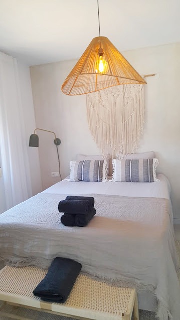 Expertly laundered linens and professionally folded towels on a beautifully presented bed for a holiday rental turnover in Frigiliana.