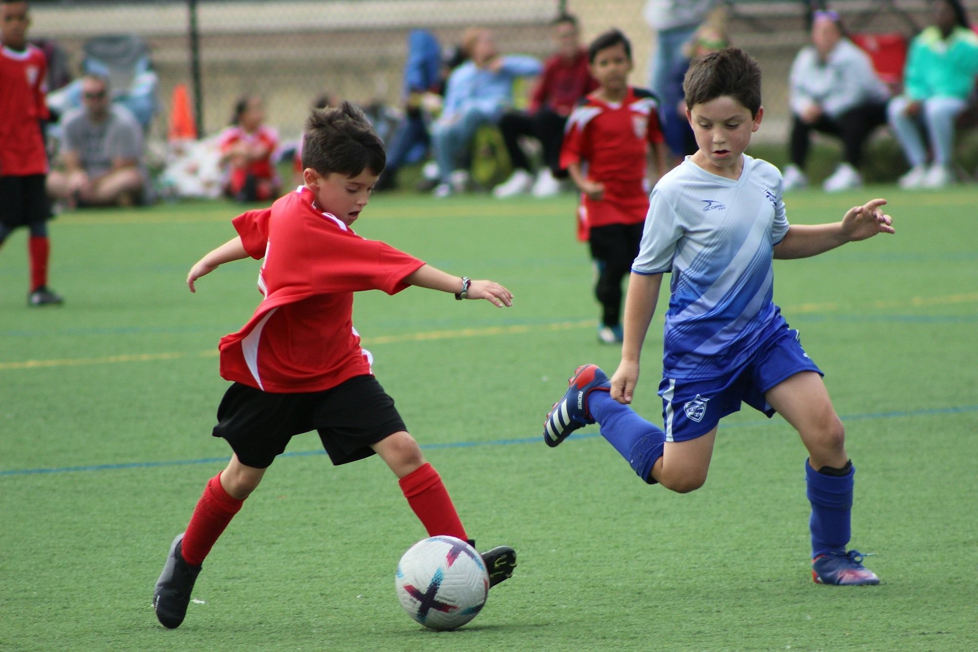 a-group-of-young-boys-playing-a-game-of-soccer-xDXdZ9wsU3s.jpg