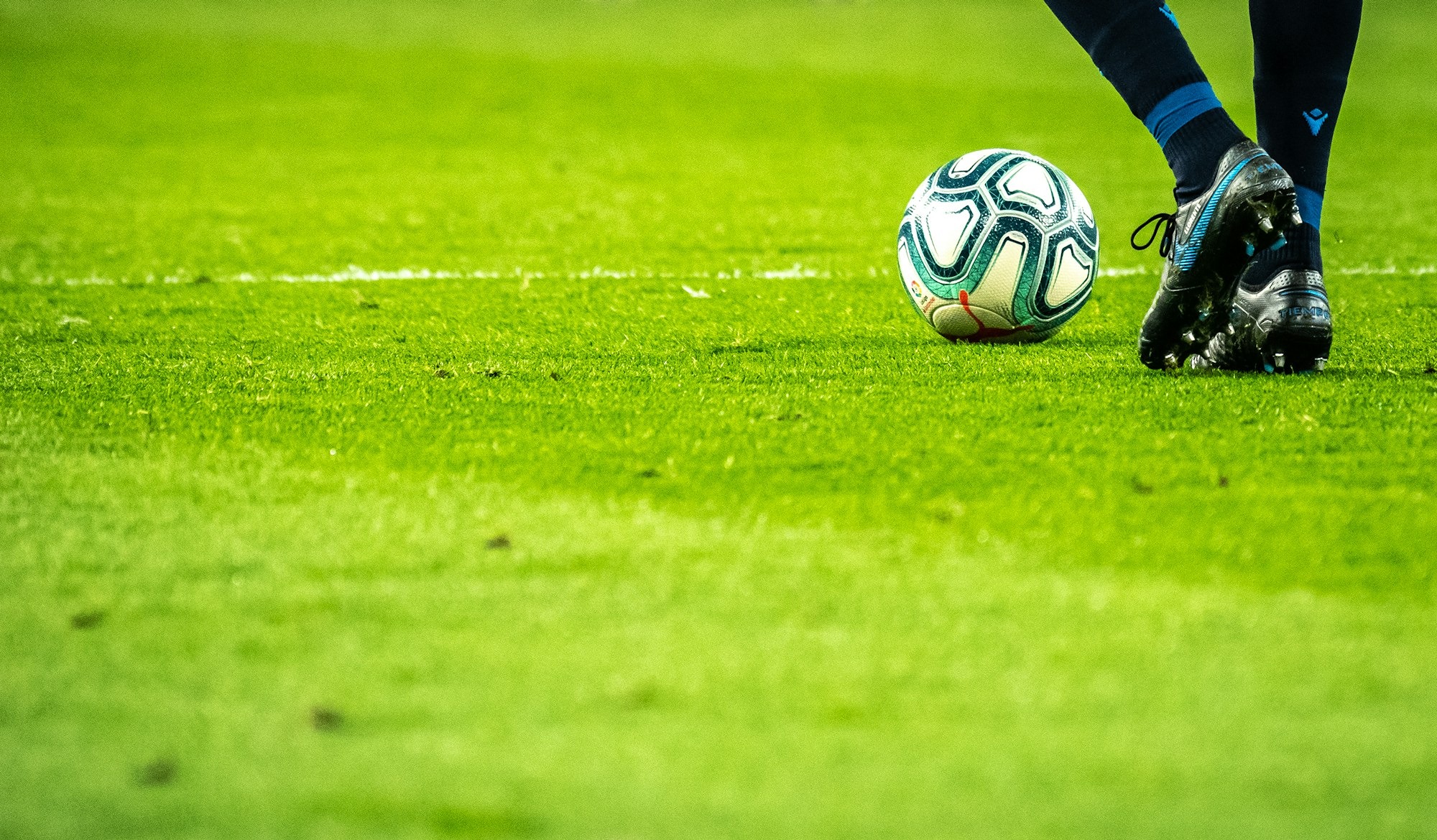 man-playing-soccer-game-on-field-AWdCgDDedH0