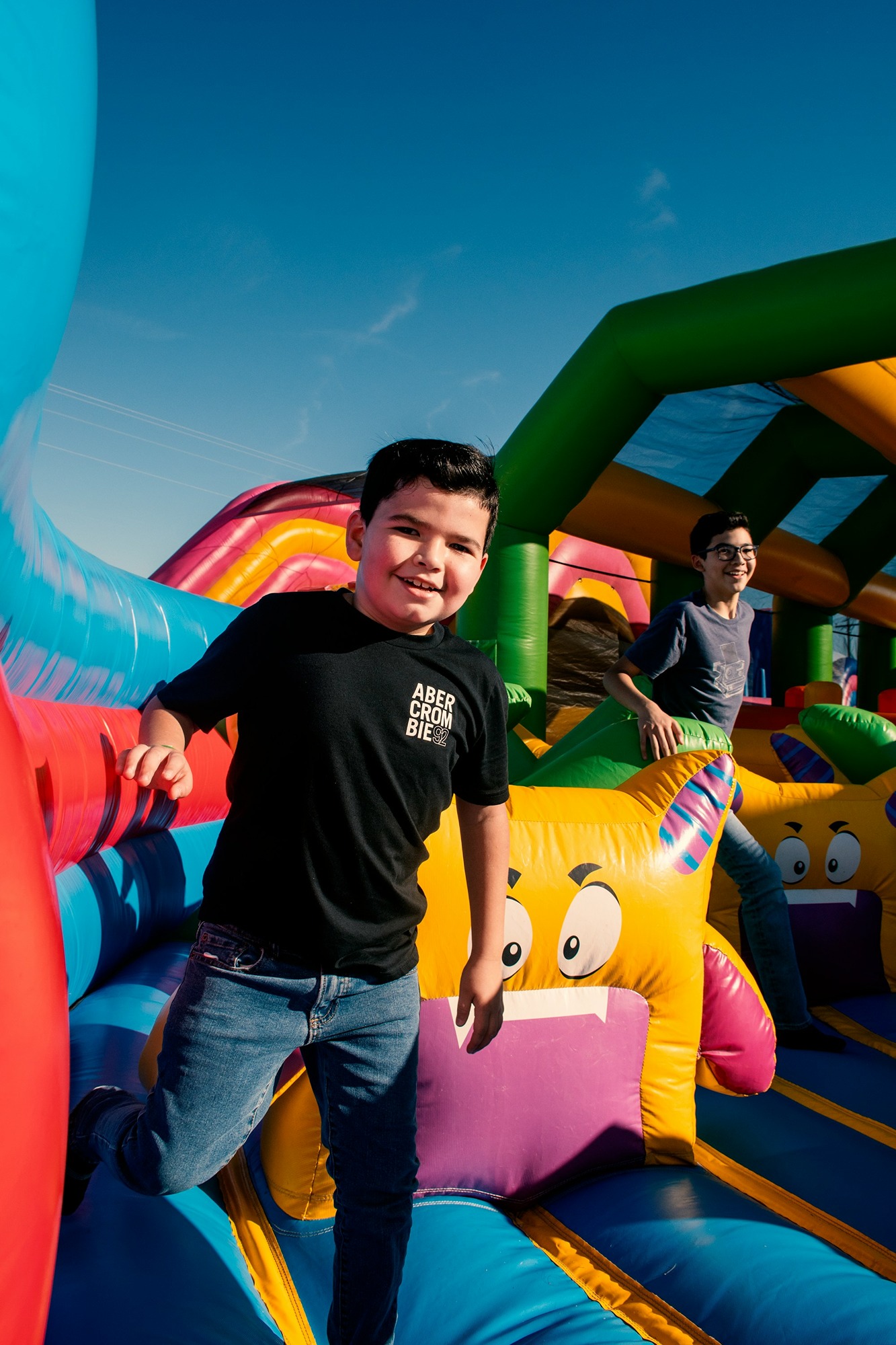 a-young-boy-standing-on-top-of-a-bouncy-castle-LMtSyylPBPI.jpg