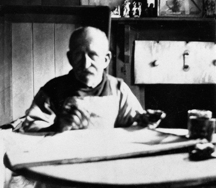 Alfred Wallis painting at his kitchen table in 1928