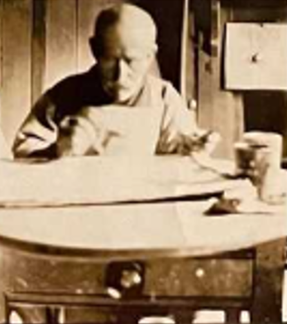 Alfred Wallis painting at his kitchen table in 1928