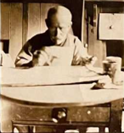 Alfred Wallis painting in his cottage in 1928